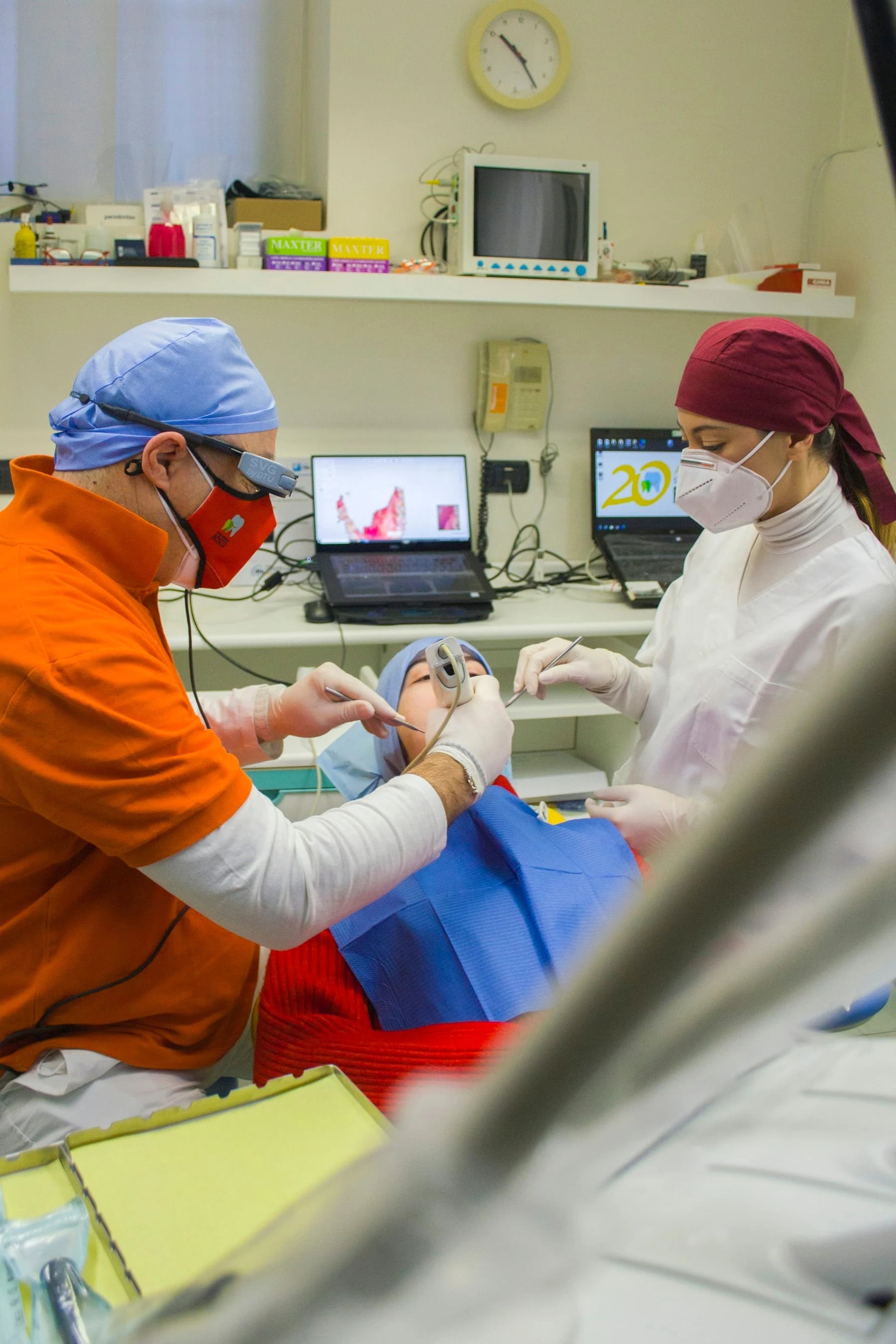 Dentist and dental assistant working together with a patient