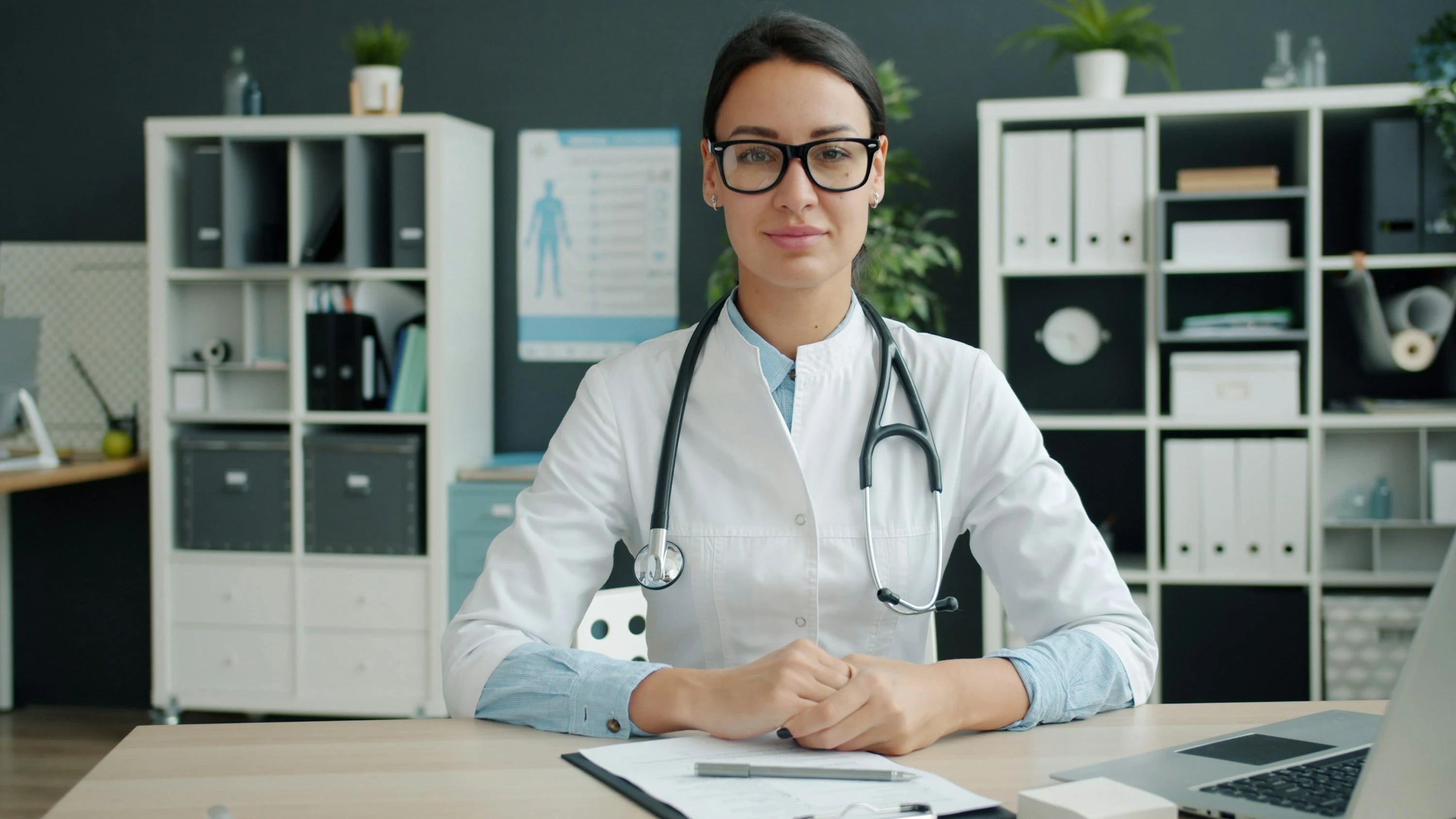 Practice owner at her desk in a consulting room